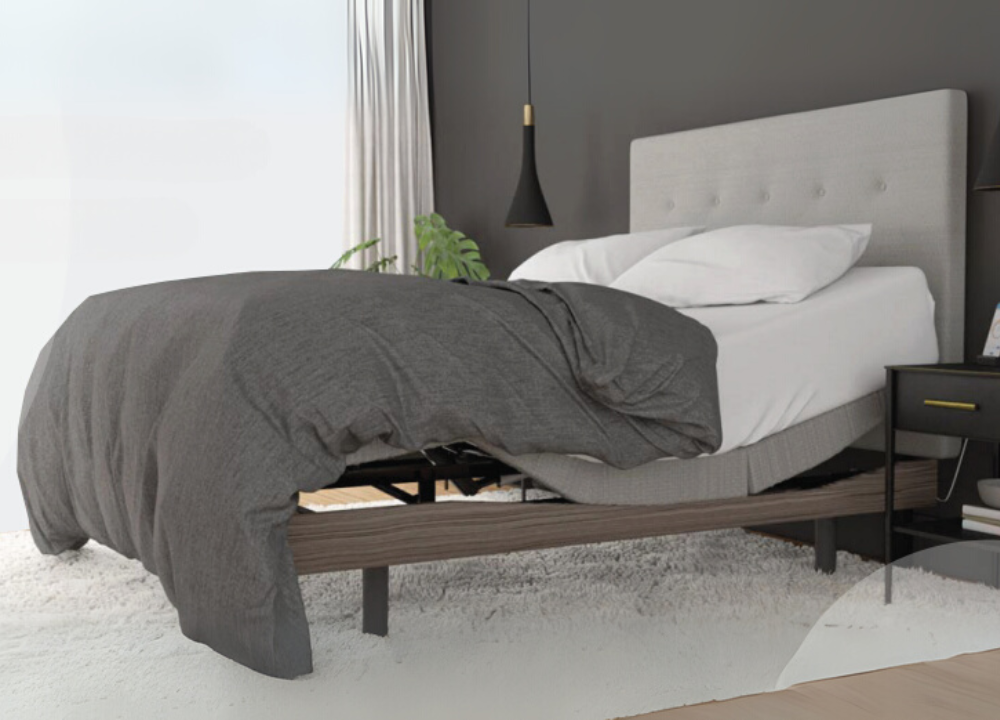 Adjustable bed base with raised head and foot sections shown in a modern bedroom setup — designed for customisable comfort, improved circulation, and better sleep posture.
